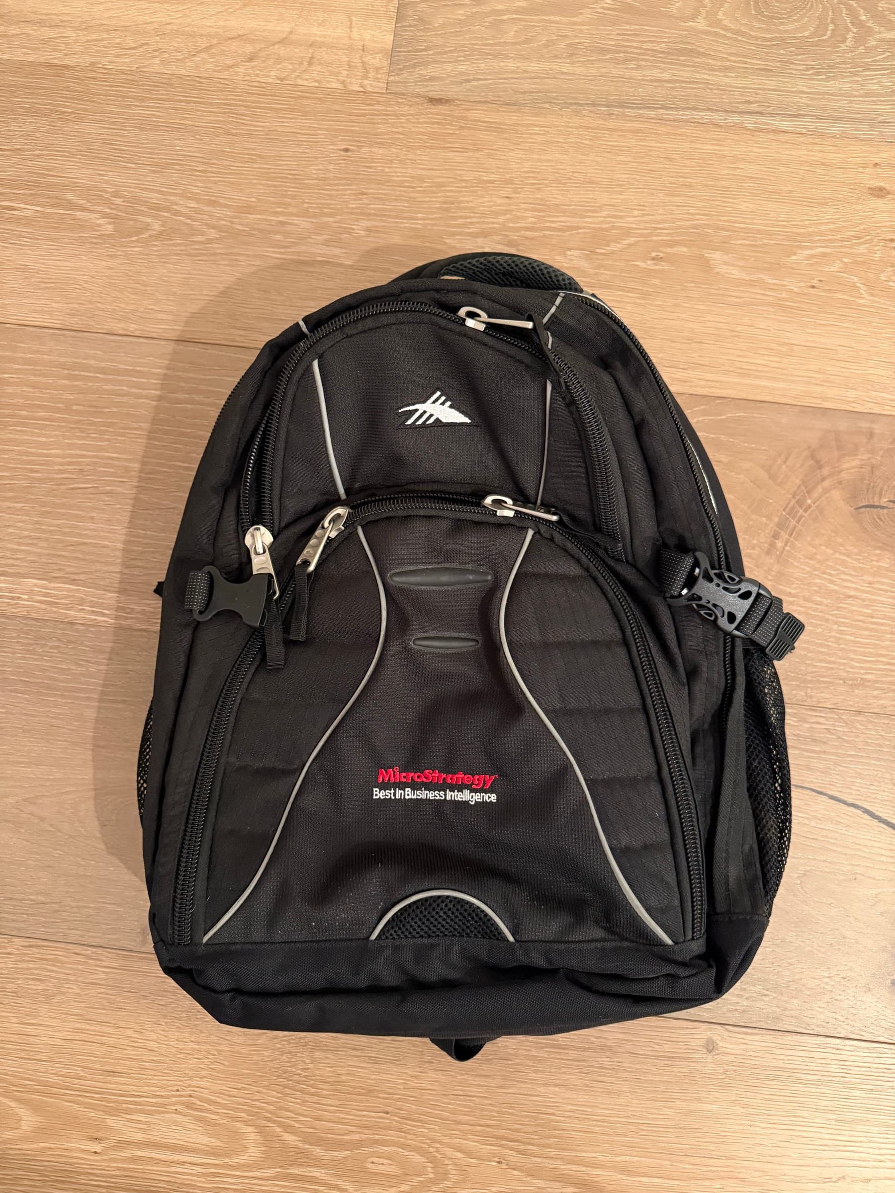 MicroStrategy-branded backpack with the company slogan on the front